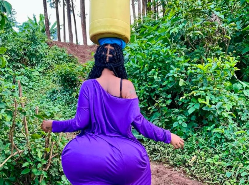 Kenyan socialite Vera Sidika carrying water up a hill. PHOTO/@queenveebosset/Instagram