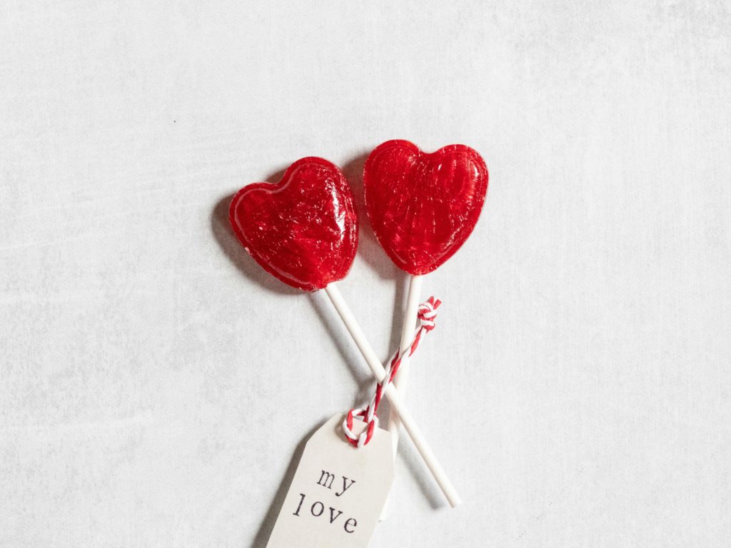 Two red heart shaped lollipops with a love tag,image is used for representation purposes. PHOTO/Pexel