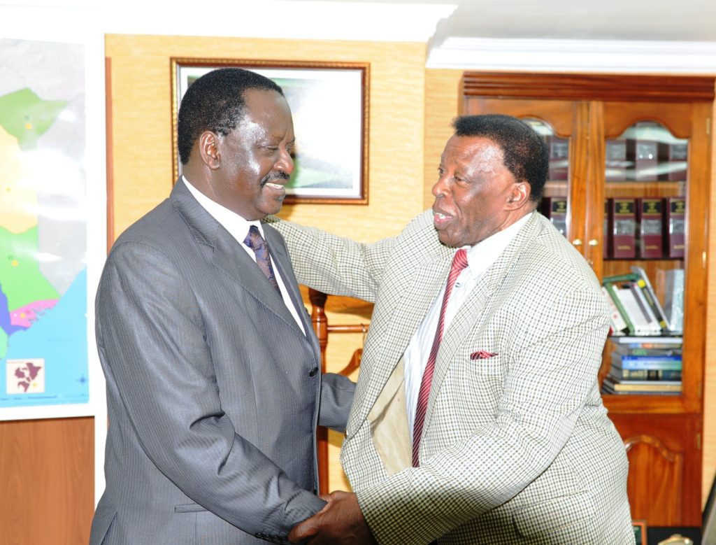 Former Prime Minister Raila Odinga and the late veteran broadcaster Leonard Mambo Mbotela during a past interaction.