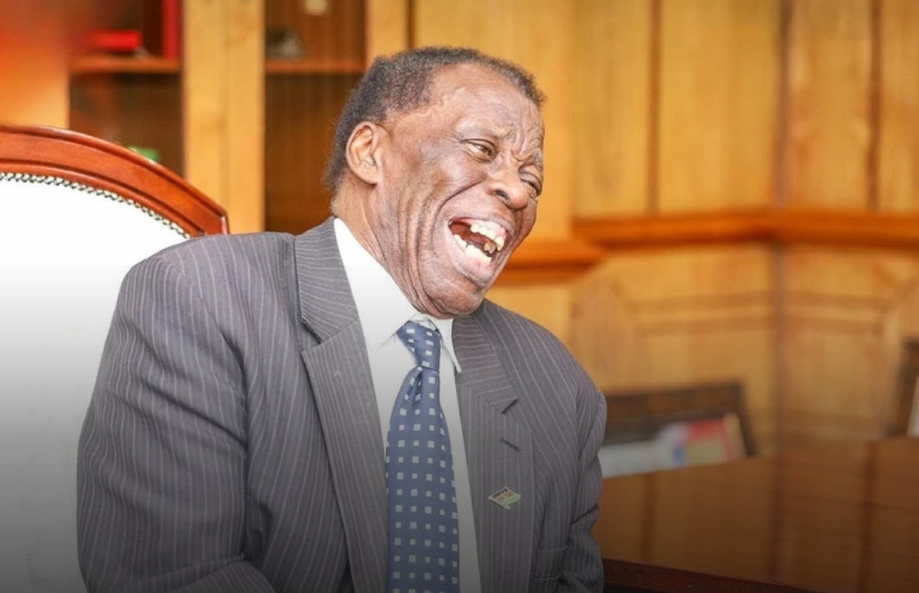 Leonard Mambo Mbotela seen laughing out loud.