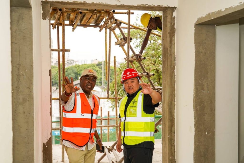 Kenya Railways Director interacting with a contractor working on the MGR line in Mombasa. PHOTO/@KenyaRailways_/X