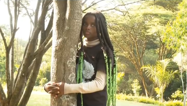 Truphena Muthoni hugs a tree at Michuki Park in Nairobi on Saturday, February 1, 2024, when she broke the Guinnes World Record of hugging a tree for long. PHOTO/Screegrab by K24 Digital from a video posted on X by @AbabuNamwamba